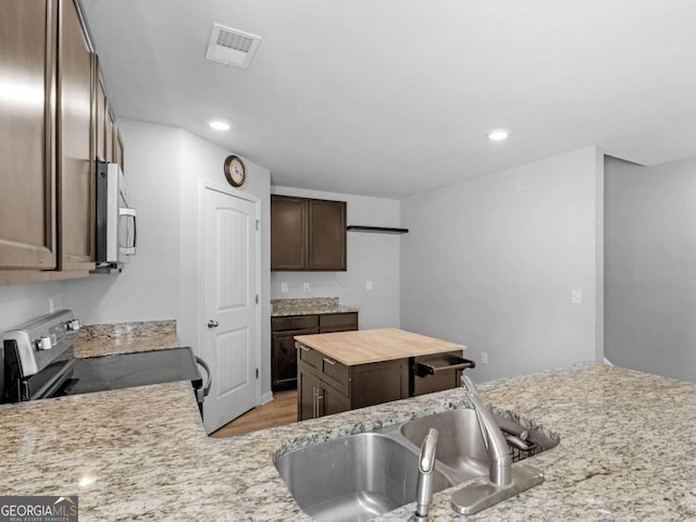 kitchen with visible vents, recessed lighting, appliances with stainless steel finishes, and dark brown cabinets