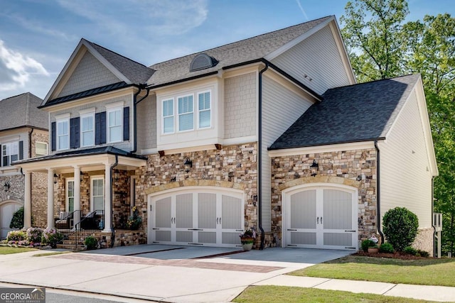 craftsman-style house featuring driveway, a porch, stone siding, and a shingled roof