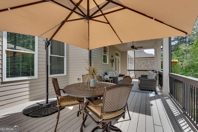 deck with outdoor lounge area, ceiling fan, and outdoor dining area
