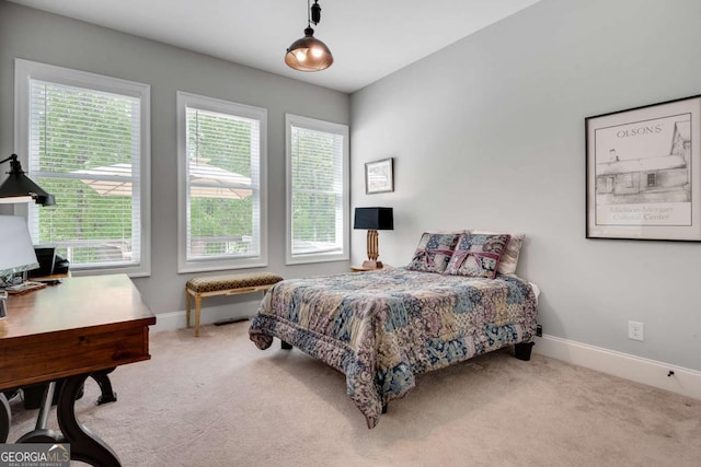 carpeted bedroom featuring baseboards