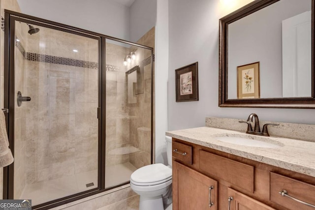 full bathroom with toilet, vanity, and a shower stall