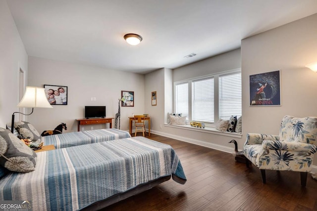 bedroom featuring wood finished floors and baseboards