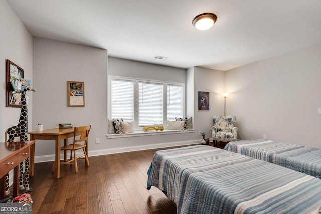 bedroom featuring dark wood finished floors and baseboards