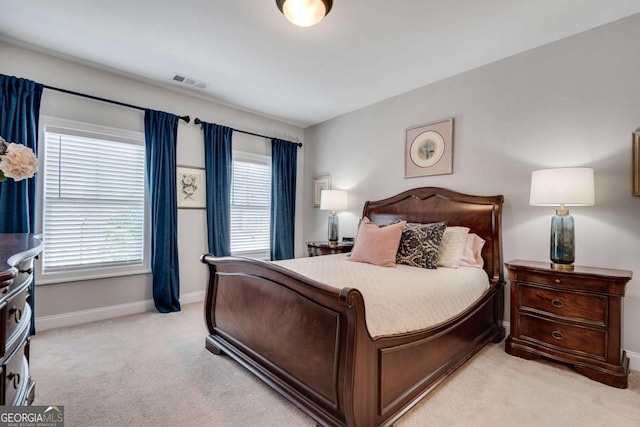 bedroom featuring light carpet and baseboards