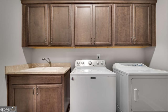 washroom featuring cabinet space and washing machine and clothes dryer