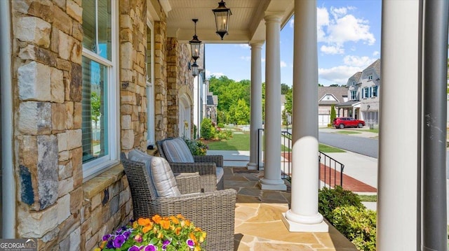 view of patio with covered porch and a residential view