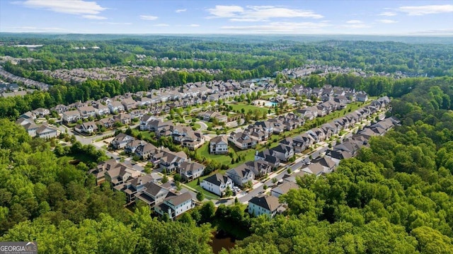 aerial view of property's location with a heavily wooded area and nearby suburban area