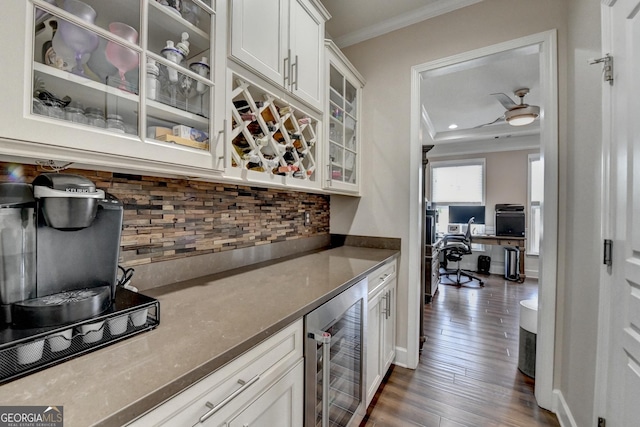 6413 Maple Park Ln, Hoschton, GA 30548 - bar with dark wood-style flooring, beverage cooler, backsplash, ornamental molding, and a bar