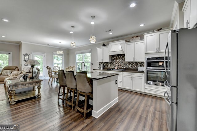 6413 Maple Park Ln, Hoschton, GA 30548 - kitchen featuring crown molding, dark countertops, a sink, stainless steel appliances, and white cabinetry