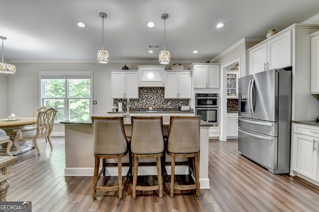 6413 Maple Park Ln, Hoschton, GA 30548 - kitchen with decorative backsplash, visible vents, crown molding, appliances with stainless steel finishes, and white cabinets