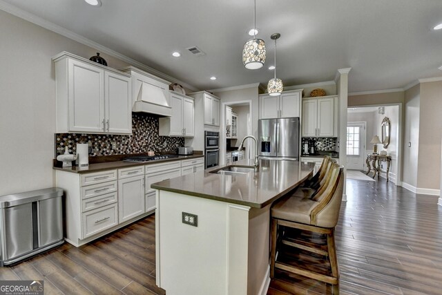 6413 Maple Park Ln, Hoschton, GA 30548 - kitchen featuring visible vents, appliances with stainless steel finishes, a sink, custom exhaust hood, and ornamental molding