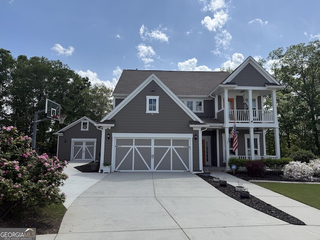 greek revival house with a porch, an attached garage, and driveway