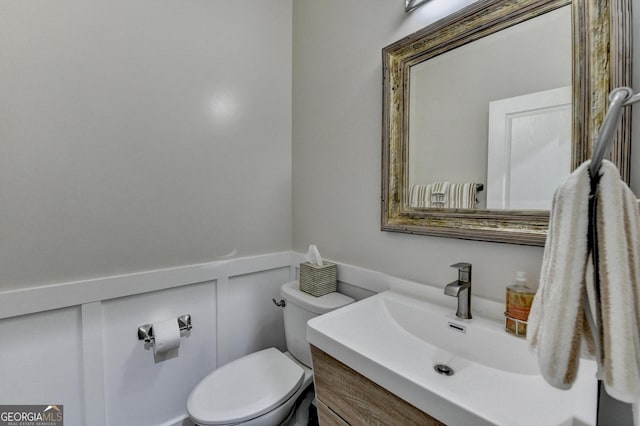 6413 Maple Park Ln, Hoschton, GA 30548 - bathroom with vanity, a wainscoted wall, a decorative wall, and toilet