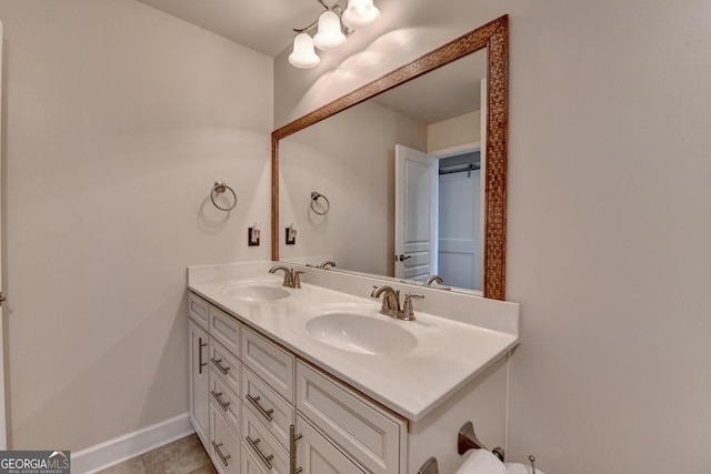 6413 Maple Park Ln, Hoschton, GA 30548 - bathroom featuring double vanity, a sink, baseboards, and an inviting chandelier