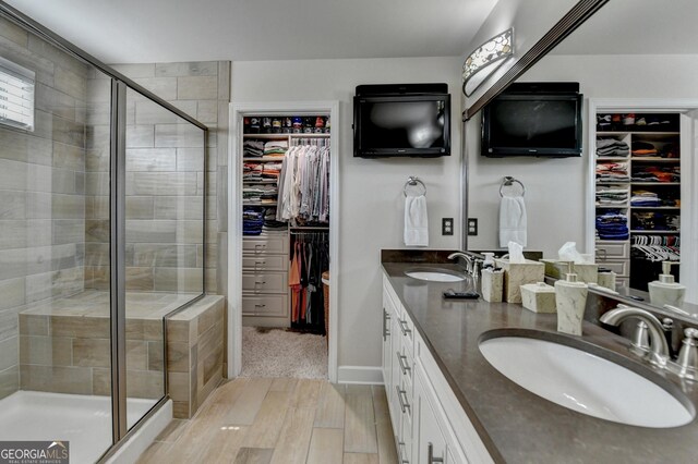 6413 Maple Park Ln, Hoschton, GA 30548 - full bathroom featuring a sink, a stall shower, and wood finished floors