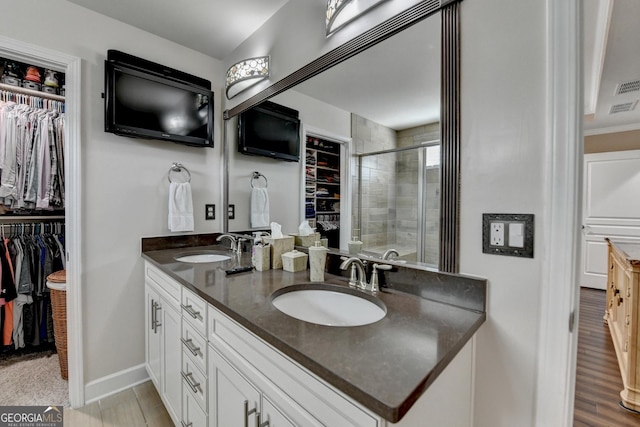 6413 Maple Park Ln, Hoschton, GA 30548 - full bathroom with double vanity, a sink, a spacious closet, and a shower stall