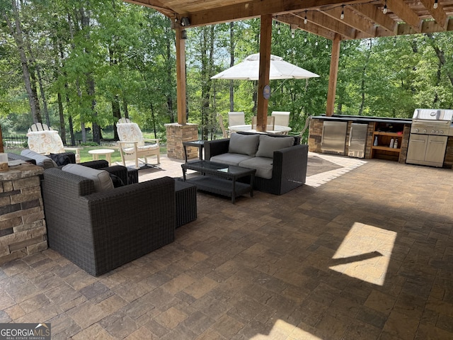 view of patio / terrace featuring an outdoor kitchen, an outdoor hangout area, a pergola, and a grill