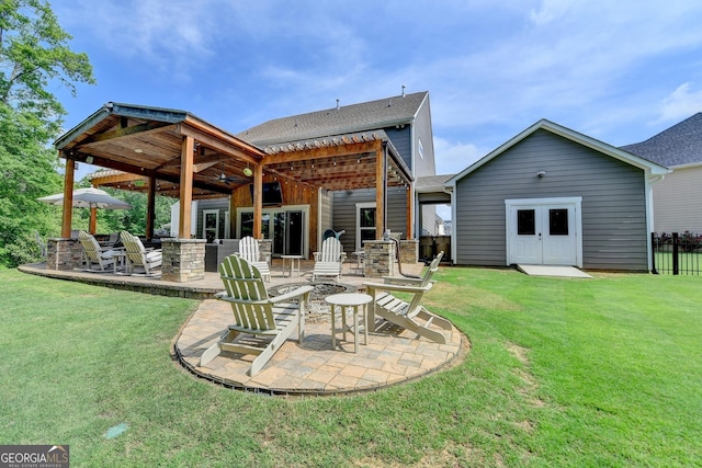 6413 Maple Park Ln, Hoschton, GA 30548 - rear view of house with a yard, roof with shingles, a patio area, and an outdoor fire pit
