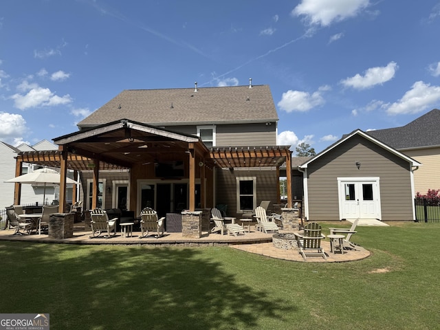 rear view of house featuring a patio area, an outdoor fire pit, a yard, and a pergola