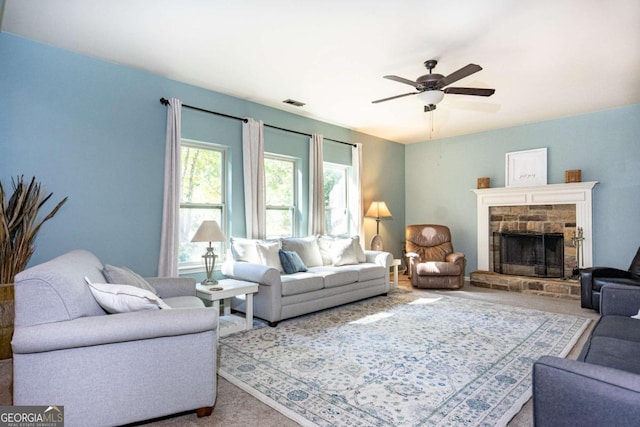 living room featuring ceiling fan, a fireplace, carpet flooring, and visible vents