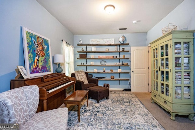 living area with carpet floors and visible vents