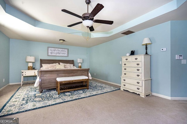bedroom featuring baseboards, carpet flooring, a ceiling fan, and a tray ceiling