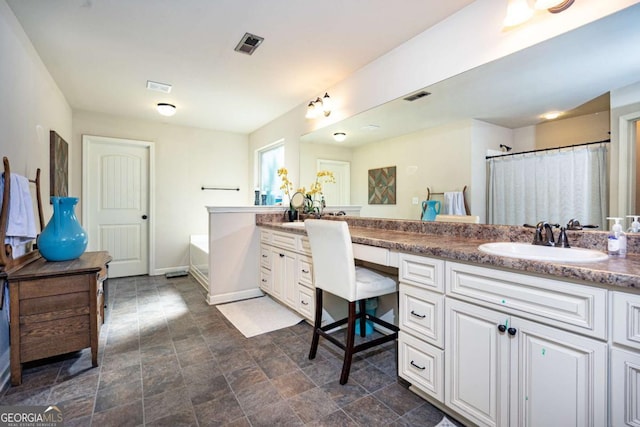 full bath featuring visible vents, stone finish flooring, baseboards, and vanity