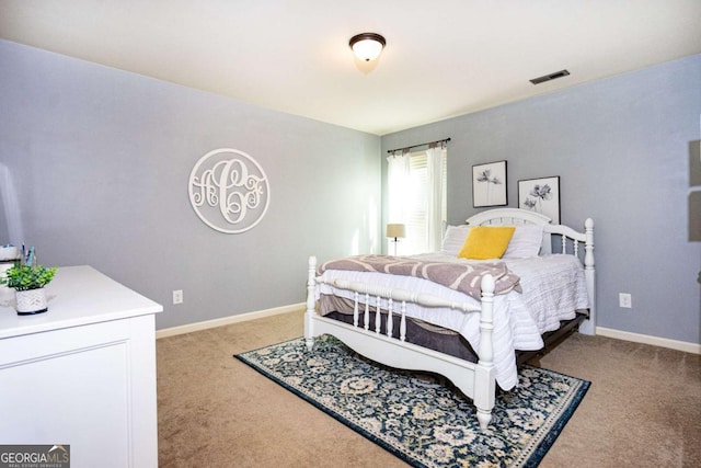carpeted bedroom featuring baseboards and visible vents