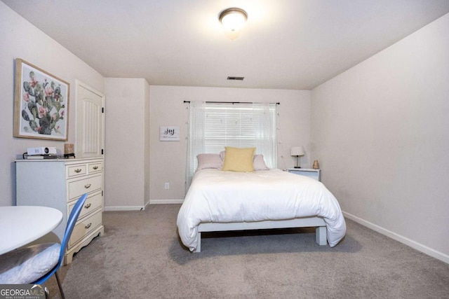 bedroom featuring baseboards, light colored carpet, and visible vents