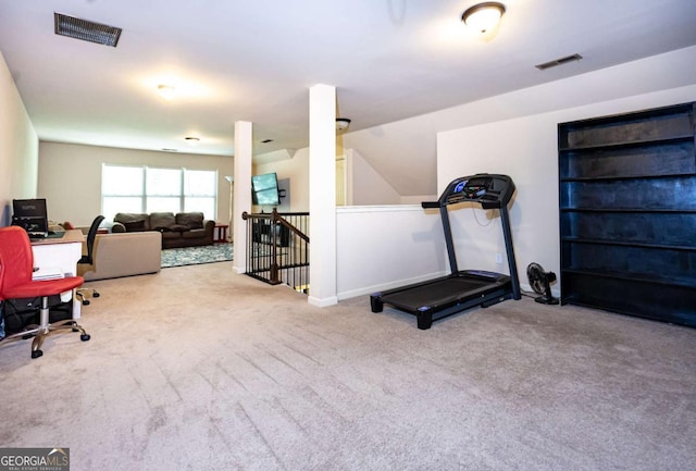 exercise area featuring visible vents and carpet