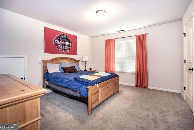 carpeted bedroom featuring baseboards and visible vents