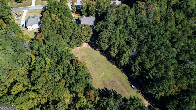 drone / aerial view with a wooded view