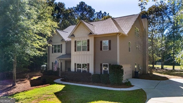 view of front facade featuring a shingled roof, a garage, board and batten siding, a front yard, and driveway
