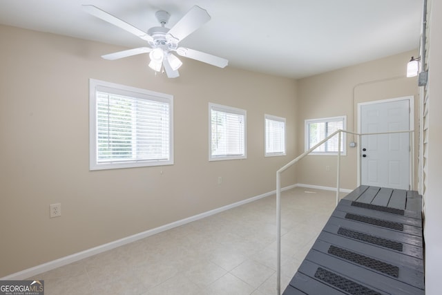 entryway with baseboards and a ceiling fan