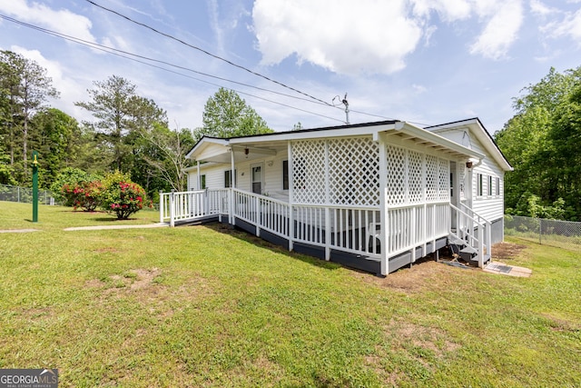 view of home's exterior with a yard and fence