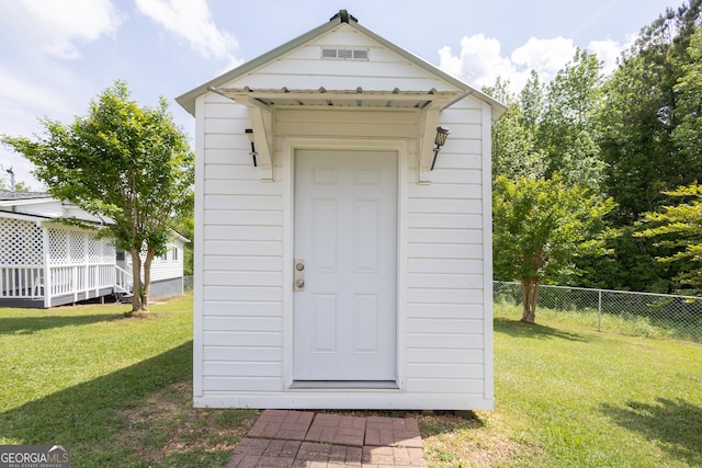 view of shed featuring fence