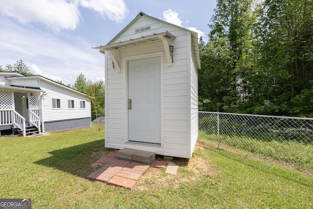 view of shed featuring fence