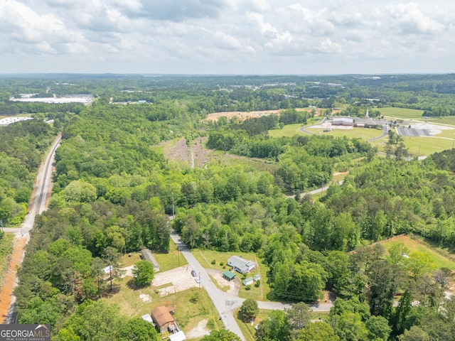 bird's eye view featuring a wooded view