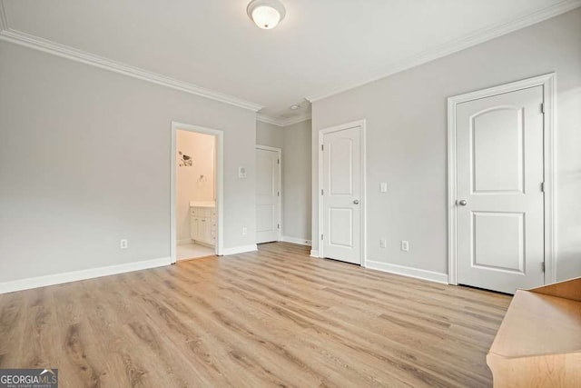 3689 Spring Hill Rd SE, Smyrna, GA 30080 - unfurnished bedroom with light wood-style floors, baseboards, crown molding, and connected bathroom