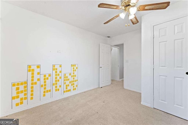 unfurnished bedroom featuring baseboards, carpet flooring, and a ceiling fan