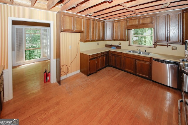 110 Vistacrest Way, Roswell, GA 30075 - kitchen featuring brown cabinets, a sink, light countertops, light wood-style flooring, and stainless steel dishwasher