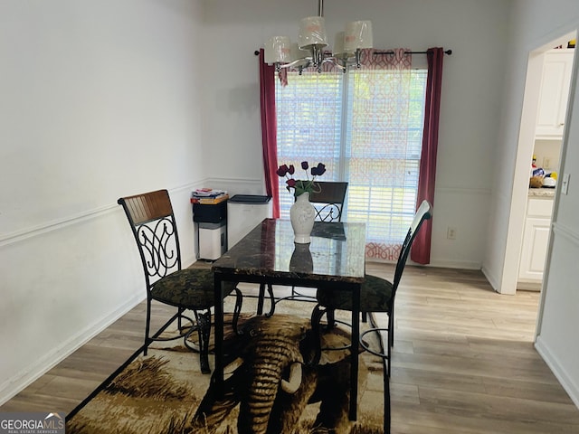 dining space with baseboards and light wood-style floors