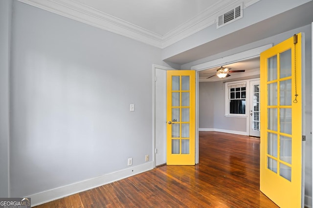 unfurnished room featuring french doors, baseboards, wood finished floors, visible vents, and ornamental molding