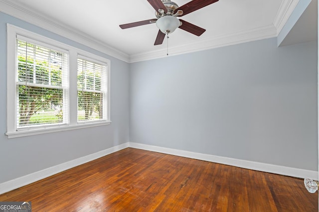 unfurnished room with baseboards, dark wood finished floors, ornamental molding, and a healthy amount of sunlight