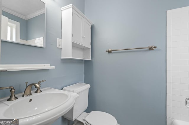 full bathroom with crown molding, a sink, toilet, a tub to relax in, and a shower