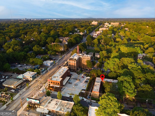 birds eye view of property featuring a wooded view