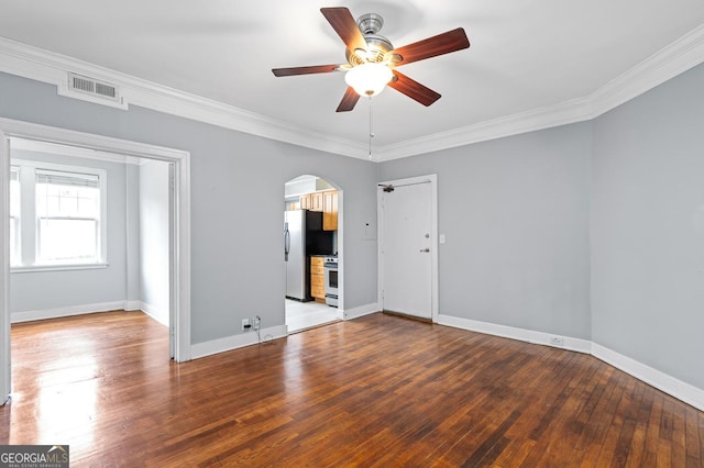 unfurnished room with a ceiling fan, visible vents, crown molding, arched walkways, and wood-type flooring