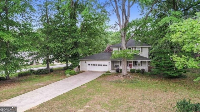 view of front facade featuring a porch, concrete driveway, a garage, and a front lawn
