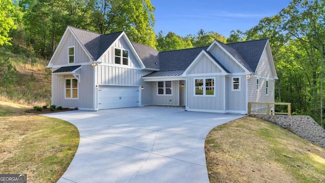 view of front of home featuring board and batten siding, a standing seam roof, concrete driveway, and roof with shingles