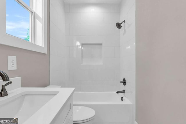 bathroom featuring washtub / shower combination, vanity, and toilet